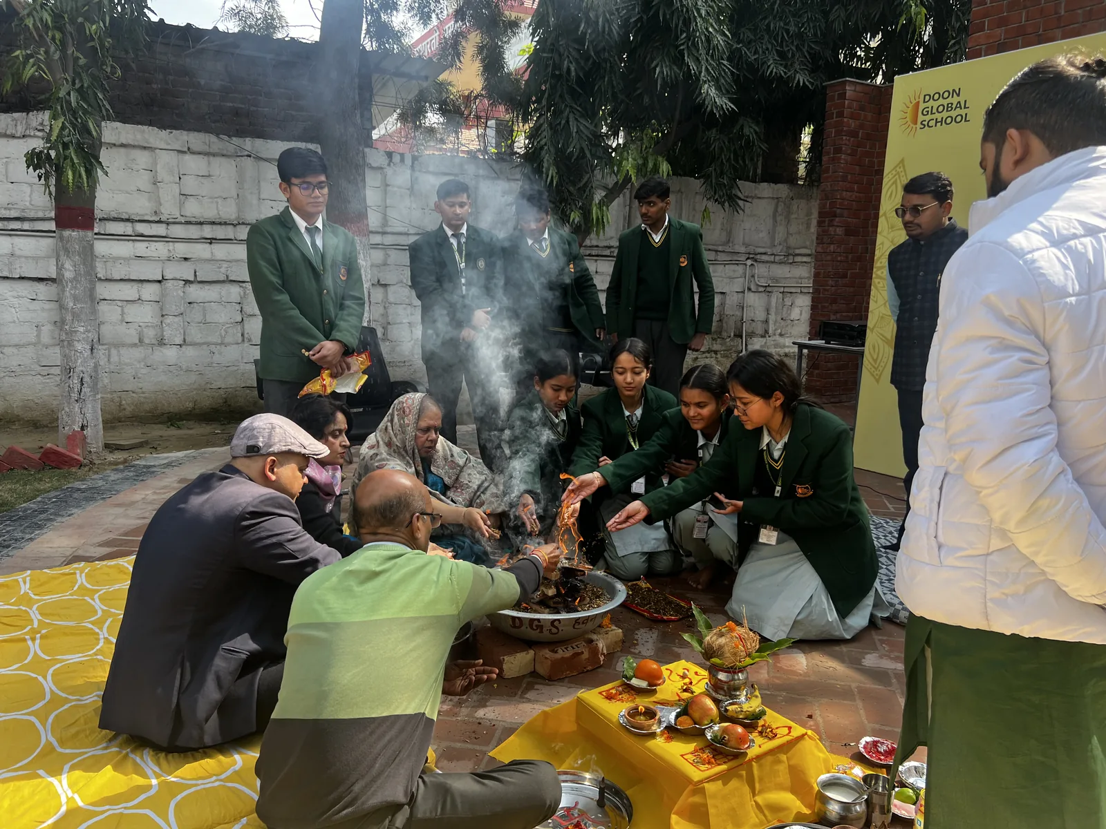 Senior students seated around the havan with teachers during the Ashirwad ceremony