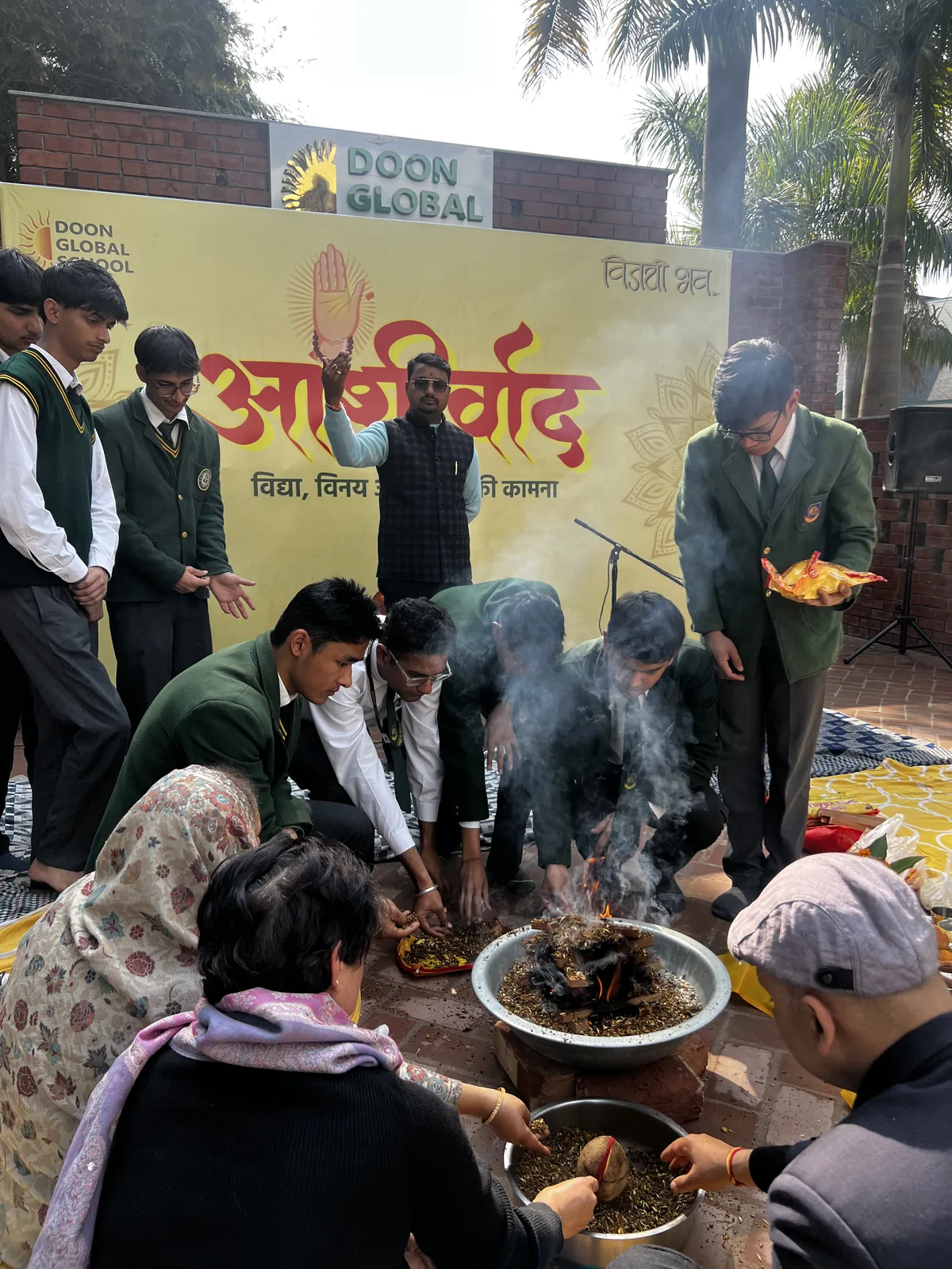 Students offering at the havan fire during the Ashirwad ceremony