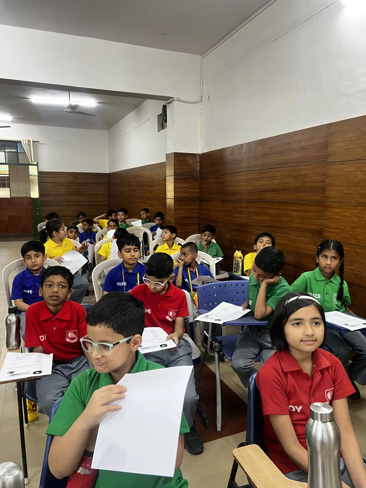 Students seated in a classroom listening to a dental health talk