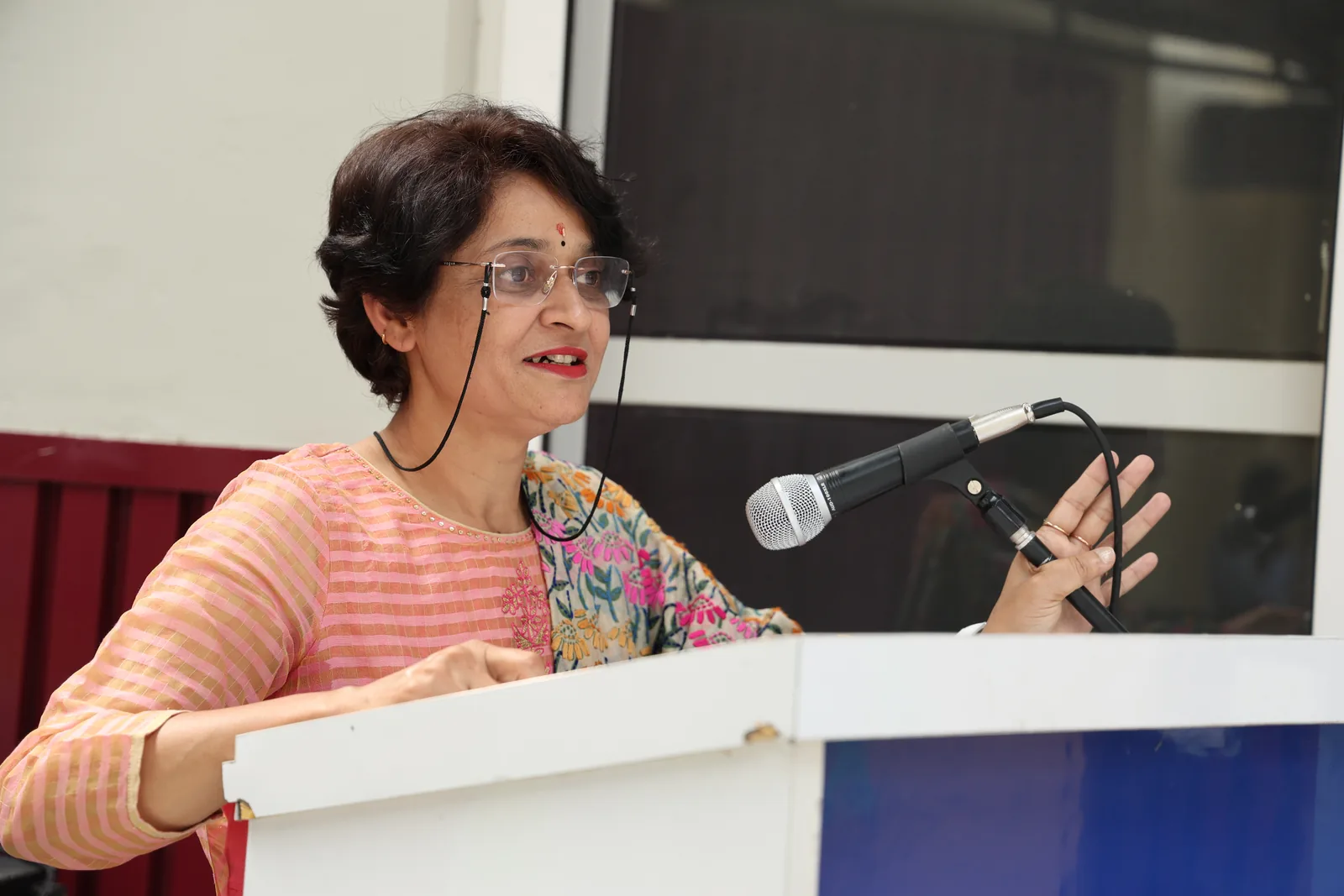 A member of staff addressing the audience from the podium