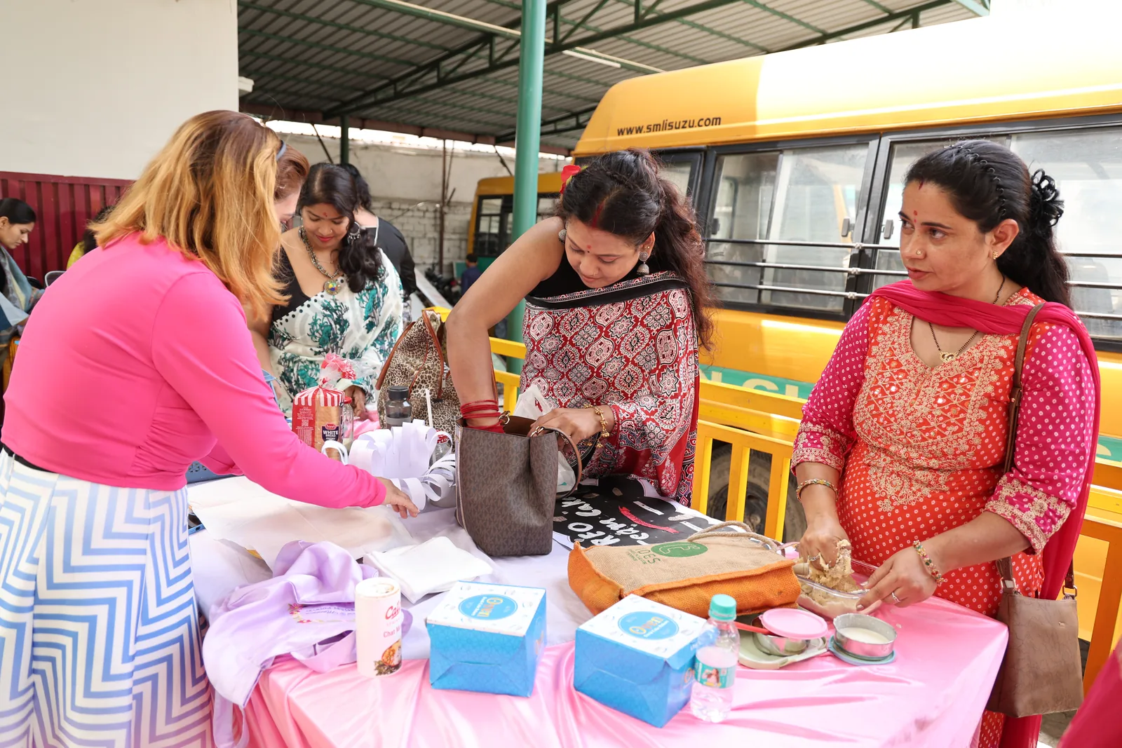 Parents at a display table beside the school buses during the event